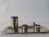 a silver tray with three cups and a spoon on it