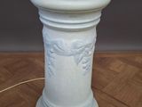 an image of a white vase with a bee on it