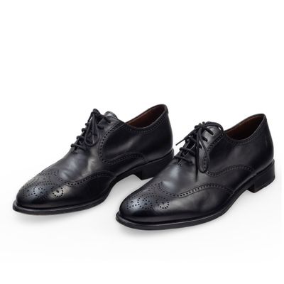 a pair of black leather shoes on a white background