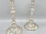 pair of silver candlesticks on a white background