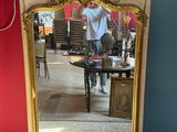 a mirror that is sitting on the floor in a room