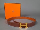 the belt is brown and has a gold buckle on it