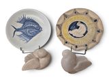 deux assiettes sur lesquelles se trouvent des poissons et un oiseau dans une assiette