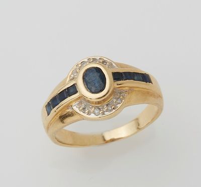 a yellow gold ring with a sapphire and diamonds