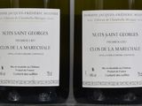 two bottles of wine that are sitting on a table