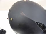 a helmet on a table with gloves on it