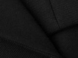 the jacket is black and has a button on the lapel