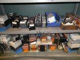many electronic devices on a shelf in a room