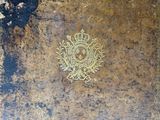 a very old book with a gold emblem on it