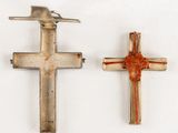 pair of silver and red crosses with a bird on top of them