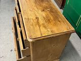 a wooden table with two drawers on top of it