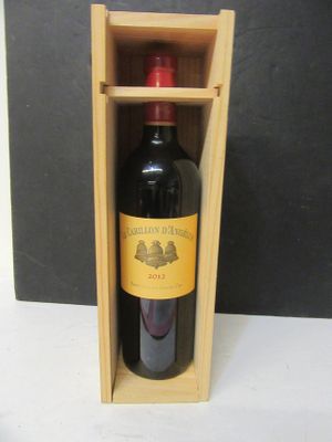 a bottle of wine in a wooden box on a table