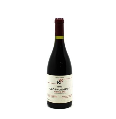 the bottle of red wine is sitting on a white surface