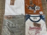 several t - shirts are wrapped in plastic and sitting on a table