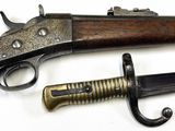 two old guns are displayed next to each other on a white surface