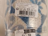 a blue and white blanket wrapped in a plastic bag