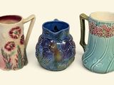 three vases sitting next to each other on a white surface