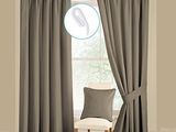 a chair in front of a window with a curtain on it