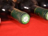 several bottles of wine are lined up on a red table