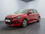 une voiture rouge dans une pièce blanche au sol noir