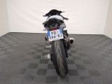 a motorcycle that is parked in a room with a checkered floor