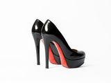 a close up of a pair of black and red high heels