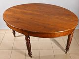 a wooden table with two legs on a tiled floor