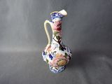 a vase with a floral design on it sitting on a table