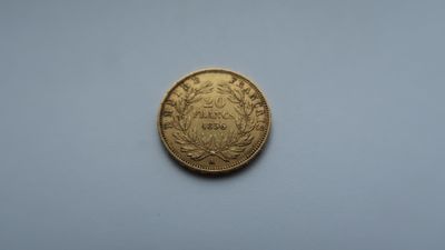 a close up of a gold coin on a white surface