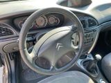 a dashboard of a car with a steering wheel and dashboard controls