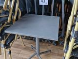 several chairs and a table in a room with a number 43 on the table