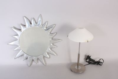 a mirror and a lamp on a table