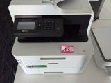 a printer sitting on top of a desk next to a printer
