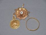 two pieces of gold and a ring with a diamond on it