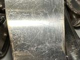 a spatula sitting on a counter with silverware in the background