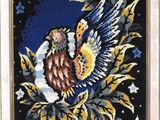 une image représentant une broderie au point de croix représentant un oiseau perché sur une branche