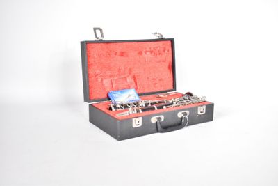 a black suitcase with a red lining and a key in it