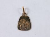 an image of a gold pendant on a white surface