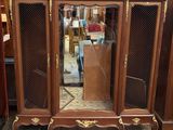 a cabinet with a mirror on top of it