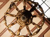 a gold colored chandelier hanging from the ceiling