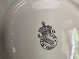a close up of a plate with a crown on it