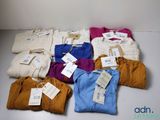 a lot of clothes that are sitting on a table