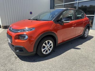 a red citrole is parked in front of a building