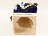 porcelain figurine of a blue and white cat sitting on top of a box