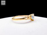 an image of a gold ring with a blue topaz stone