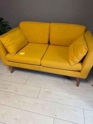 a yellow couch that is sitting on the floor