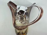a glass vase with a cow head on top of it