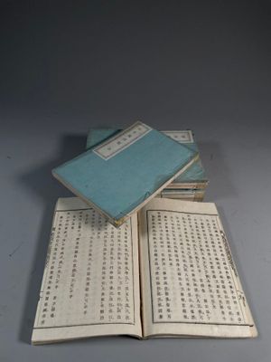 several books are stacked on top of each other on a table