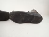 pair of black shoes on a white surface with a white background