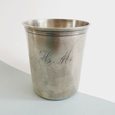 a silver cup with writing on it sitting on a table